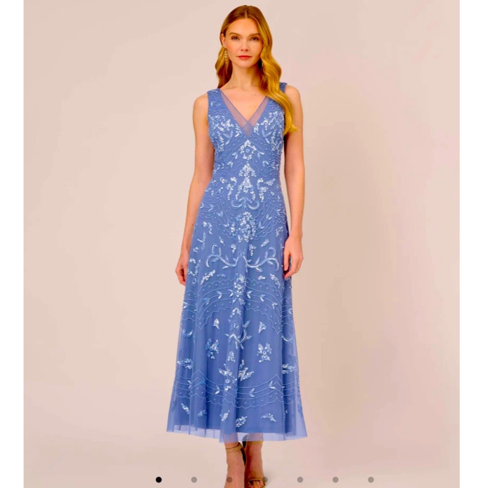 This is an ankle length sequined and beaded gown in French Blue.